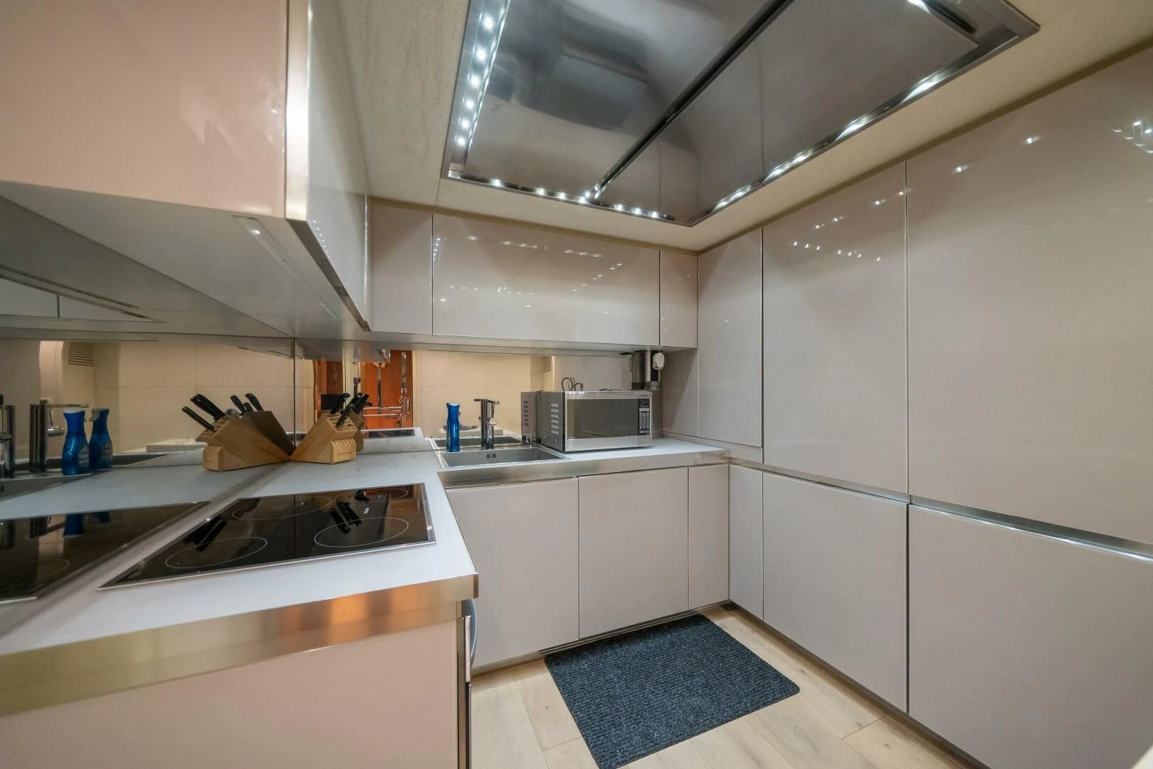 a kitchen with white cabinets aboard CERSEI Yacht for Sale