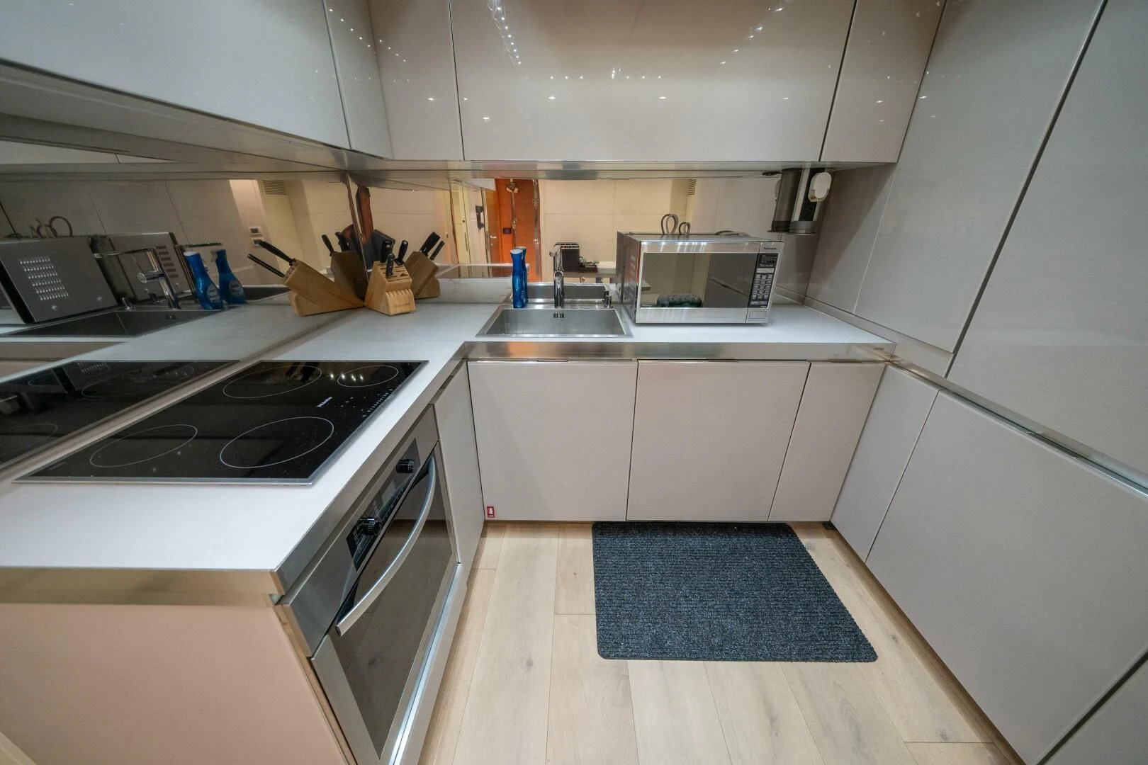 a kitchen with white cabinets aboard CERSEI Yacht for Sale