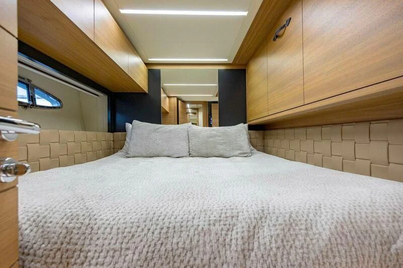 a bed with white sheets aboard CERSEI Yacht for Sale