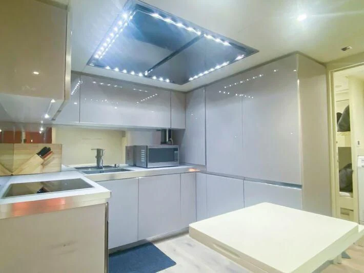 a kitchen with white cabinets aboard CERSEI Yacht for Sale