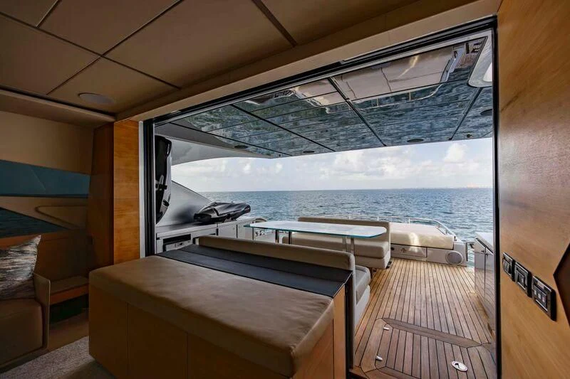 a room with a large window overlooking a body of water aboard CERSEI Yacht for Sale