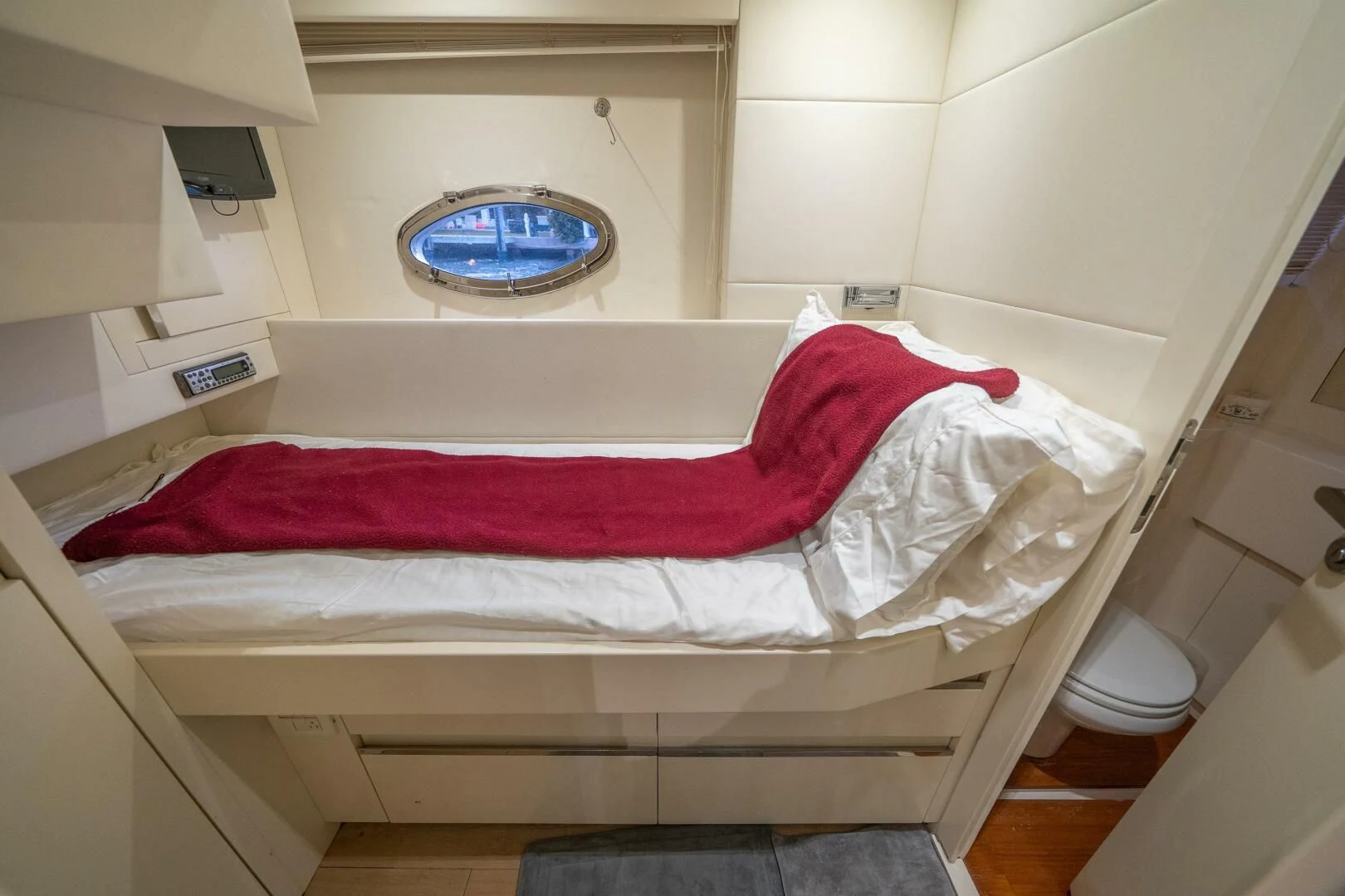 a bed with red sheets aboard CERSEI Yacht for Sale