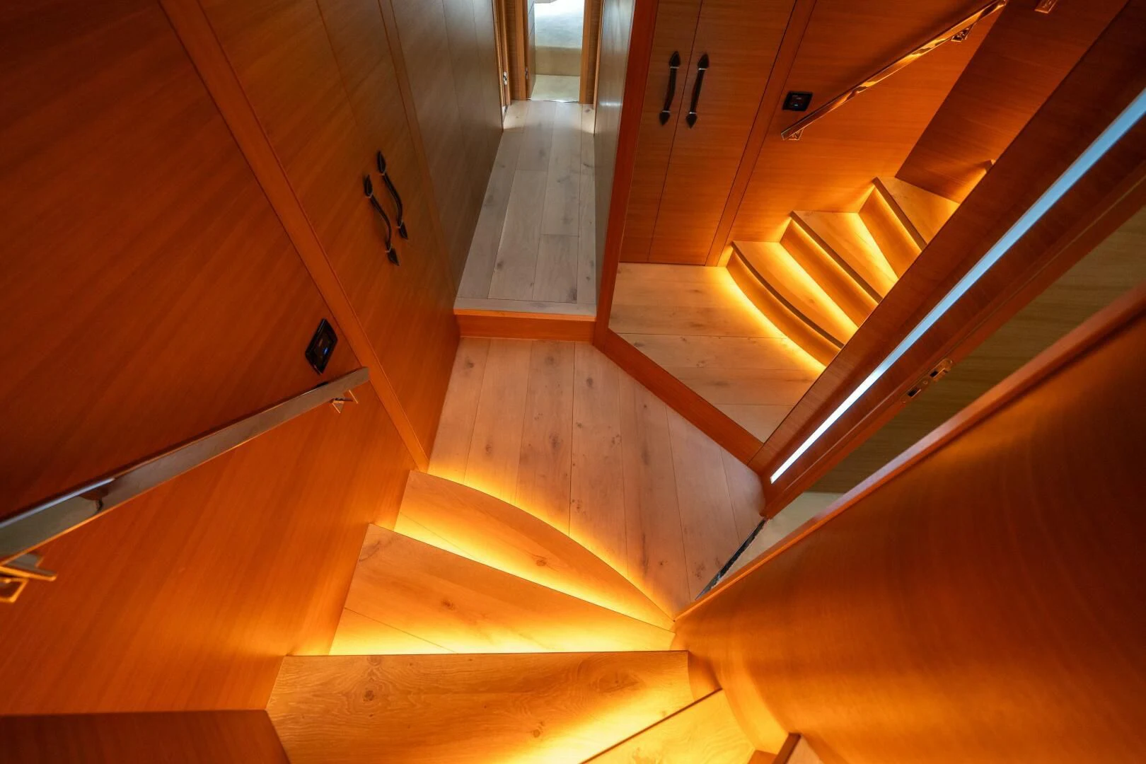 a wooden staircase with a door aboard CERSEI Yacht for Sale
