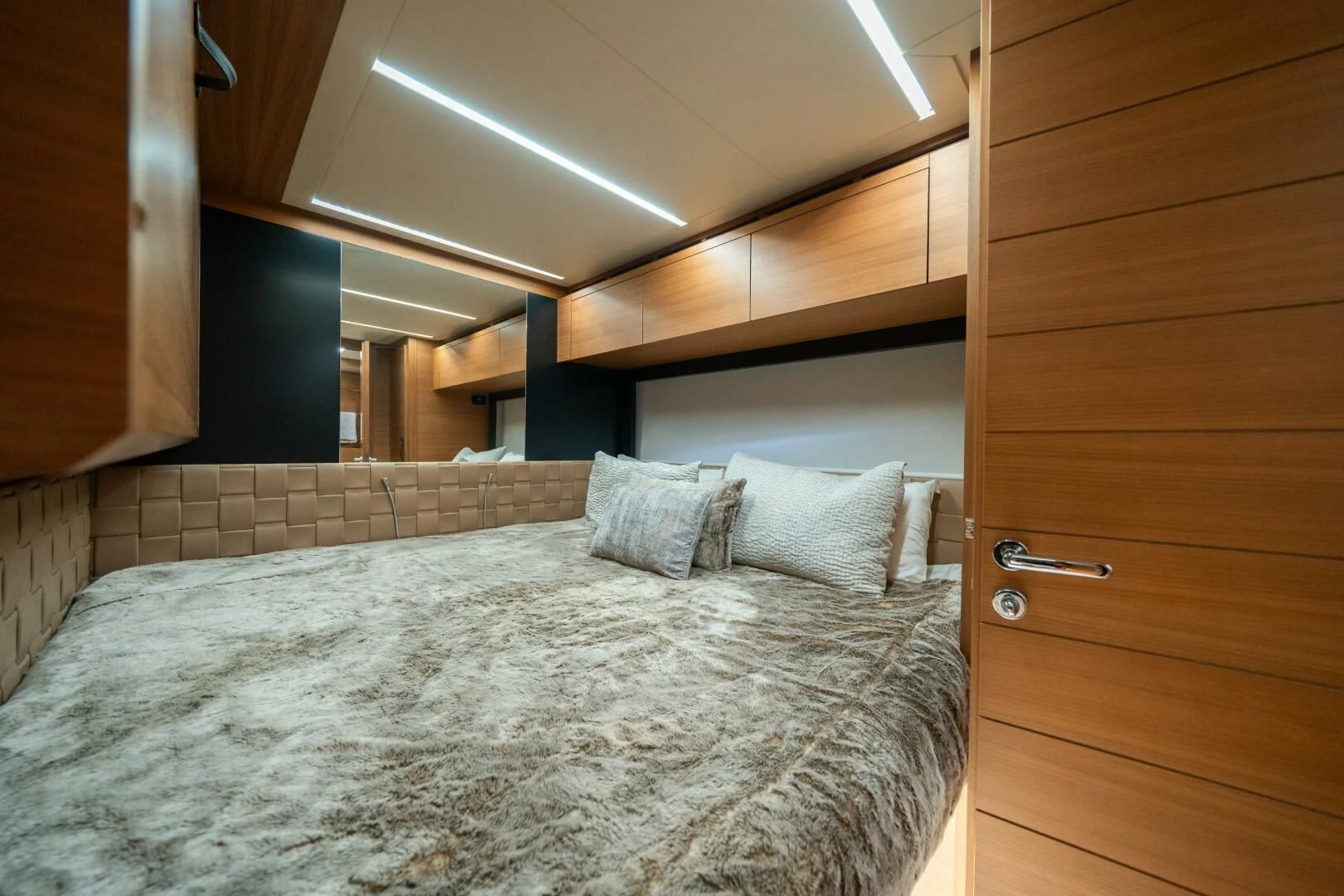 a bed with a white comforter aboard CERSEI Yacht for Sale