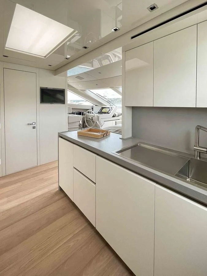 a kitchen with white cabinets aboard SANLORENZO SX88/81 Yacht for Sale