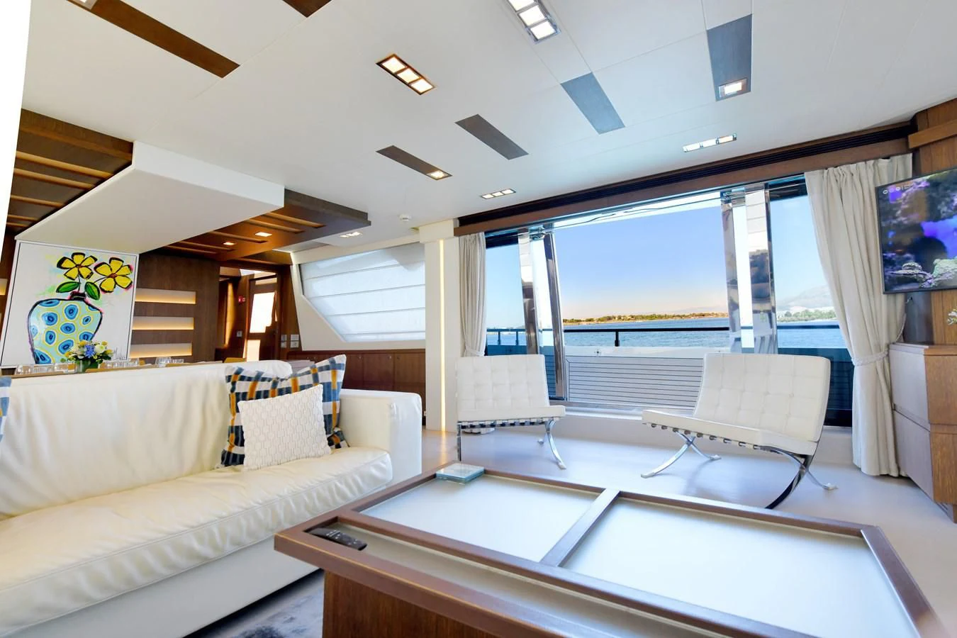 a room with a couch and a table aboard CUSTOM LINE 100 Yacht for Sale