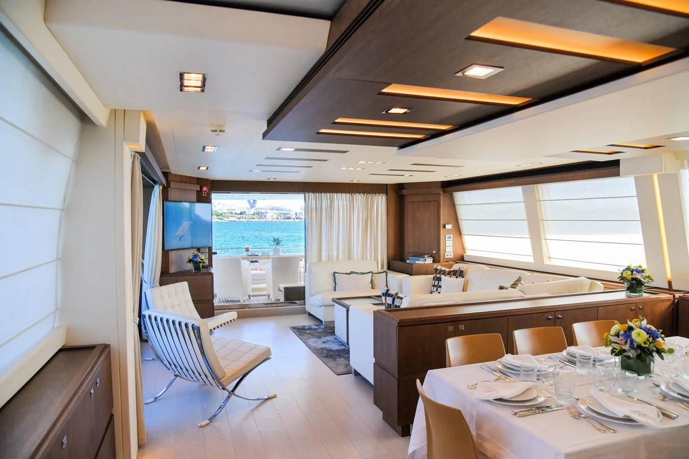 a large kitchen with a large table aboard CUSTOM LINE 100 Yacht for Sale