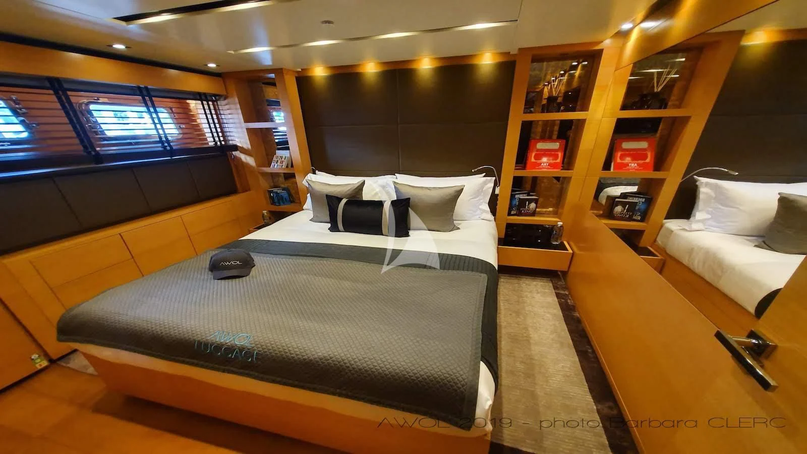 a room with a bed and a desk aboard AWAY Yacht for Charter