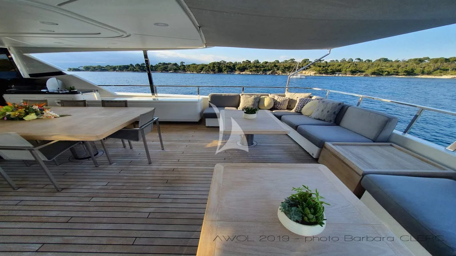a deck with a table and chairs on it aboard AWAY Yacht for Charter