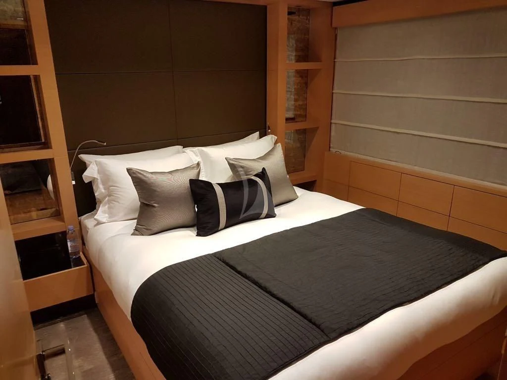 a bed with pillows aboard AWAY Yacht for Charter