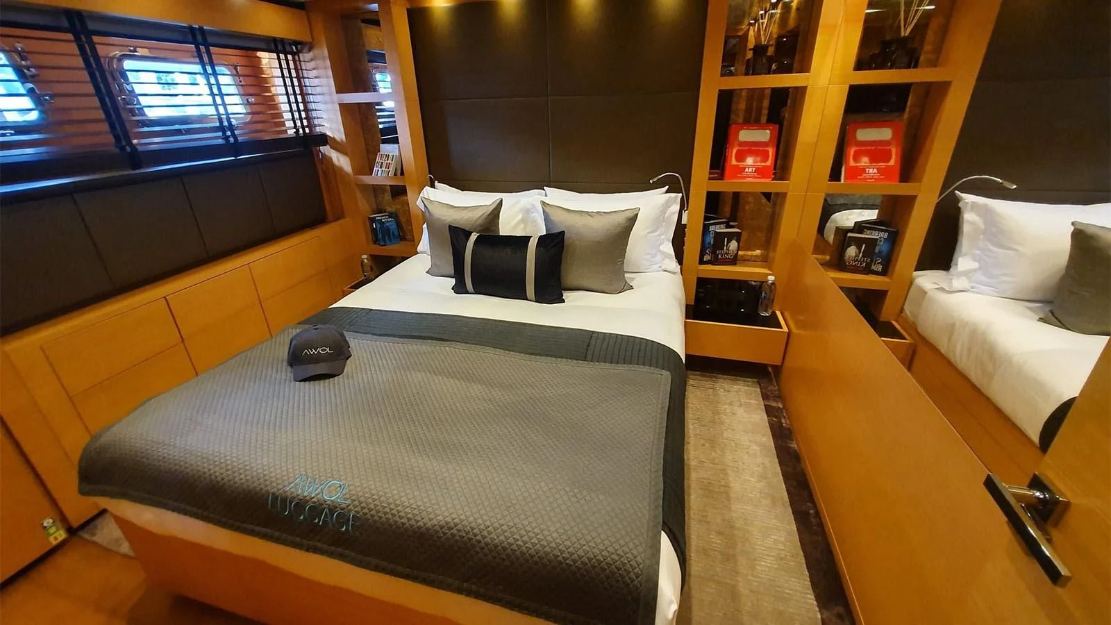 a room with a bed and a desk aboard AWAY Yacht for Charter