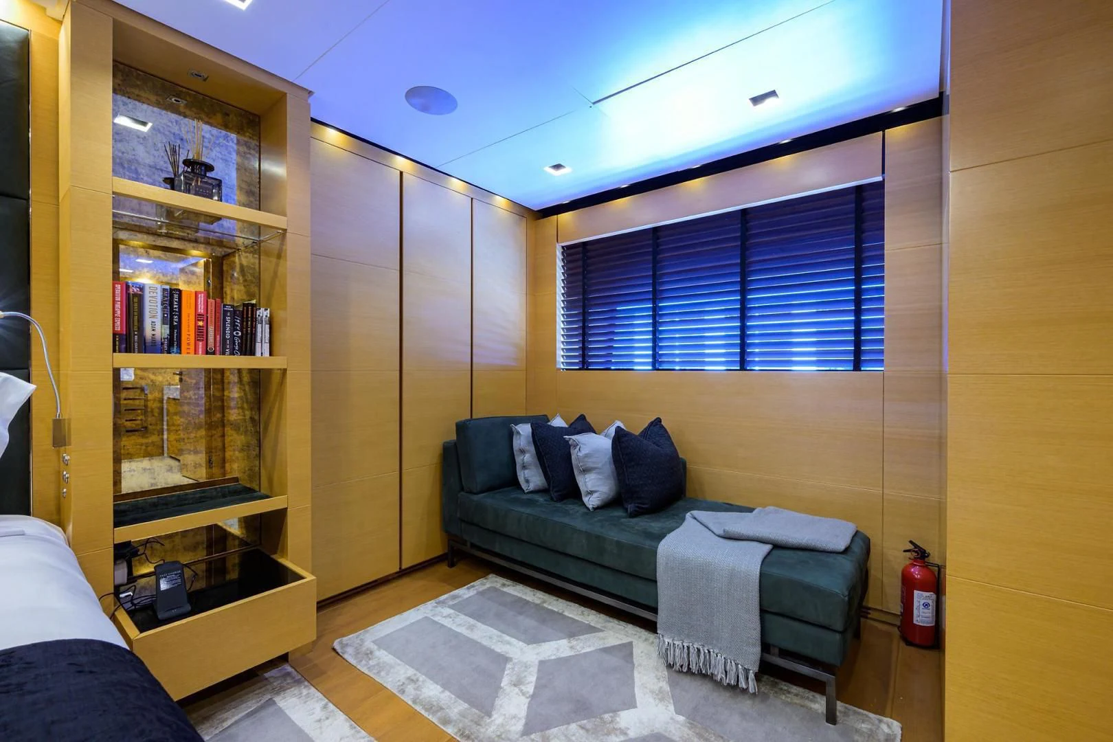 a room with a bed and a bookcase aboard AWAY Yacht for Charter