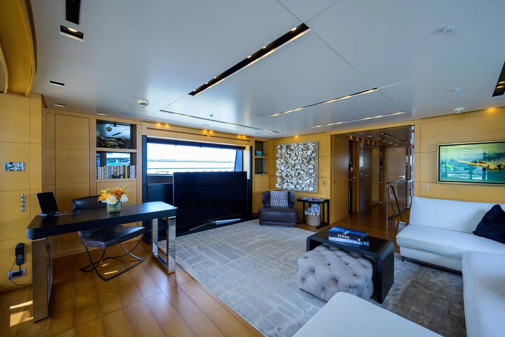 a living room with a large window aboard AWAY Yacht for Charter