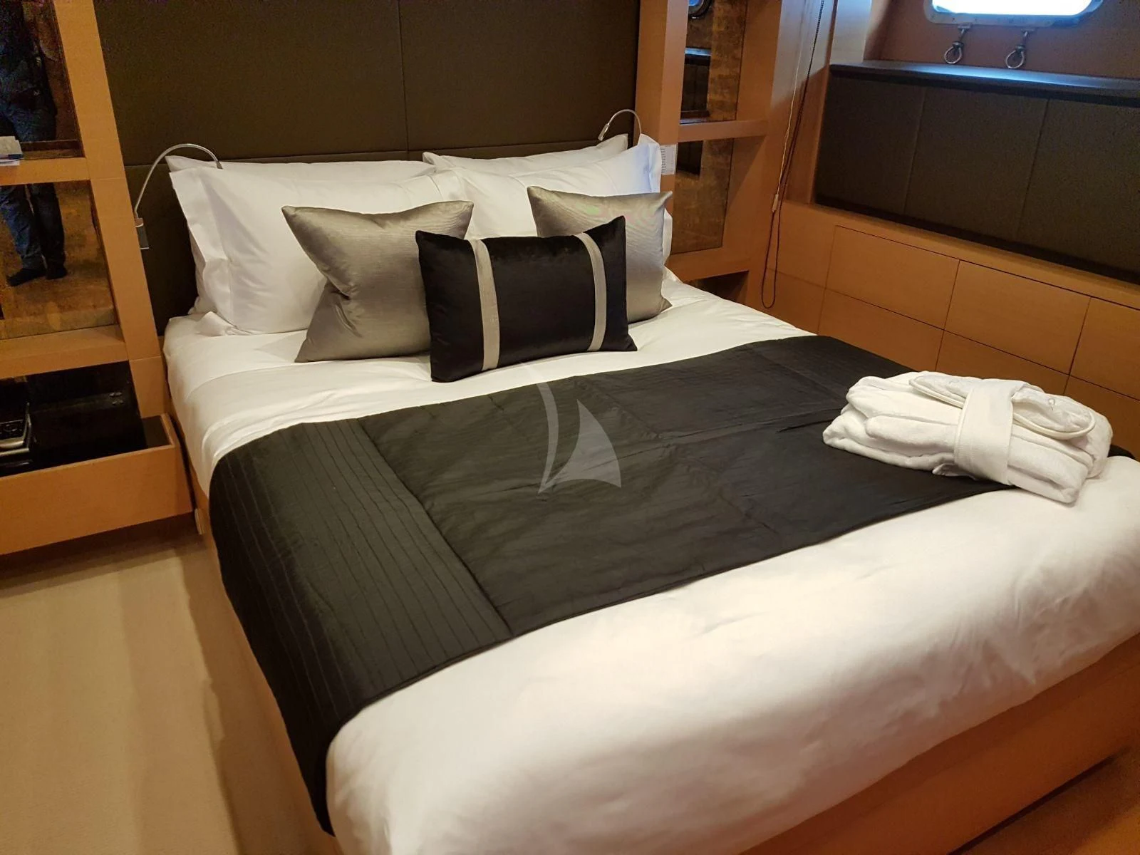 a bed with white sheets aboard AWAY Yacht for Charter