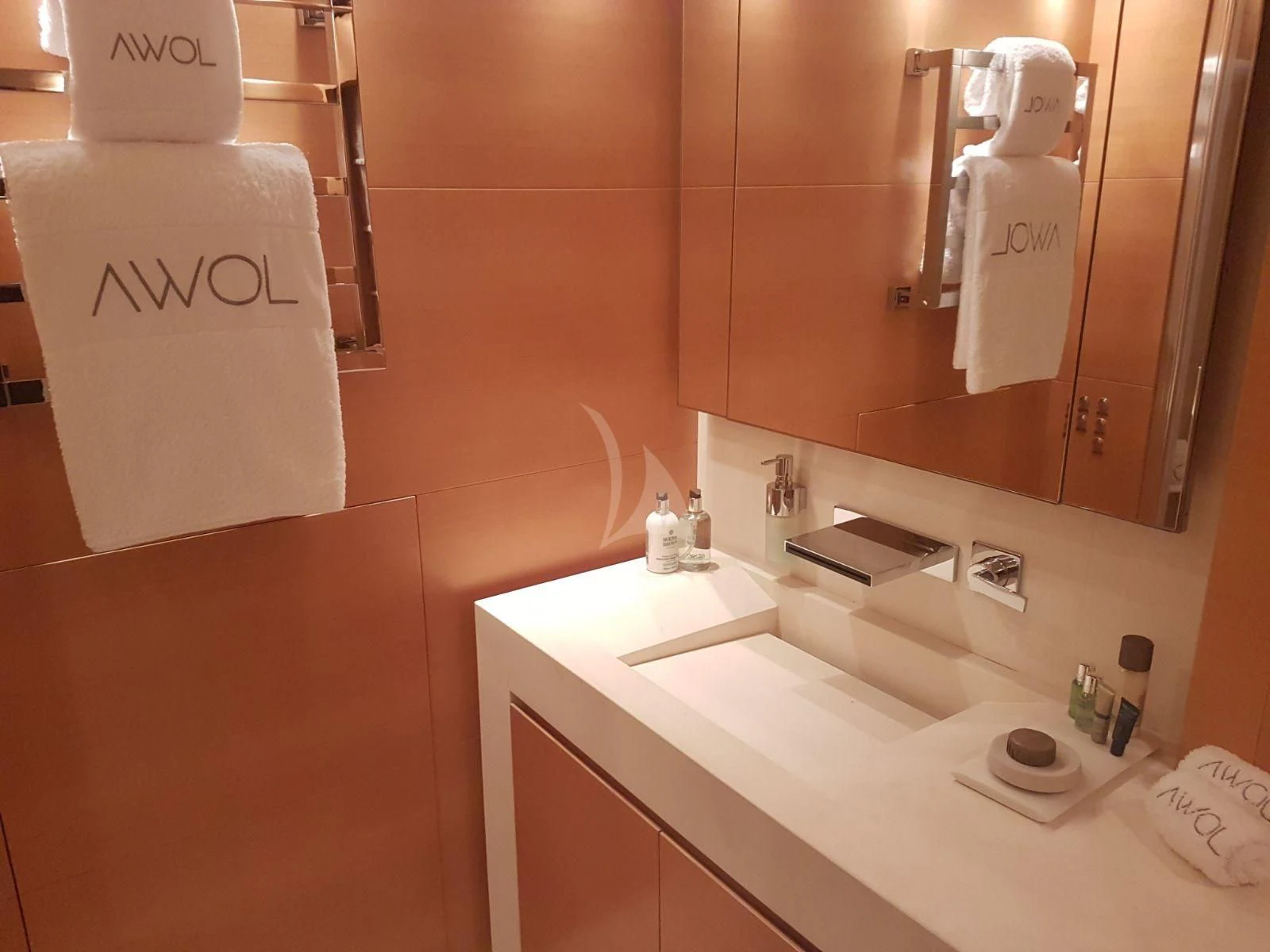 a bathroom with a mirror and a sink aboard AWAY Yacht for Charter