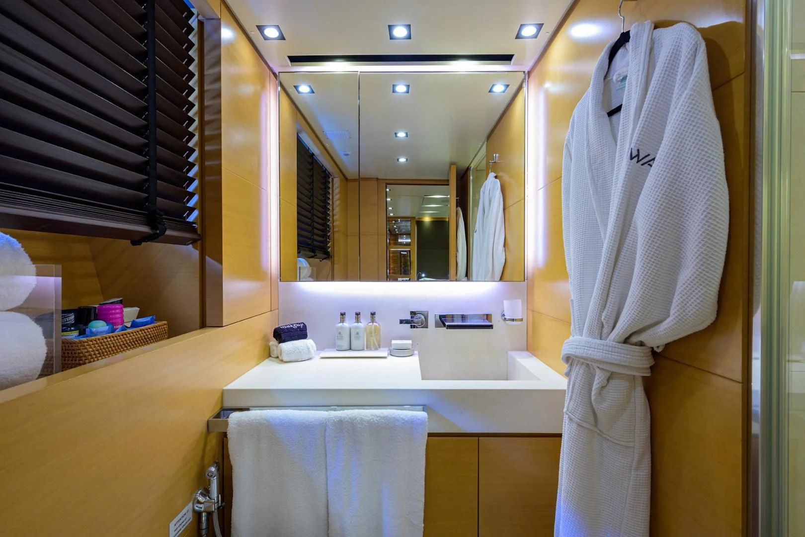 a bathroom with a robe on the wall aboard AWAY Yacht for Charter