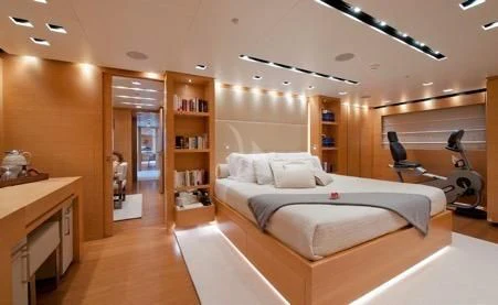 a bedroom with a bed and a desk aboard AWAY Yacht for Charter