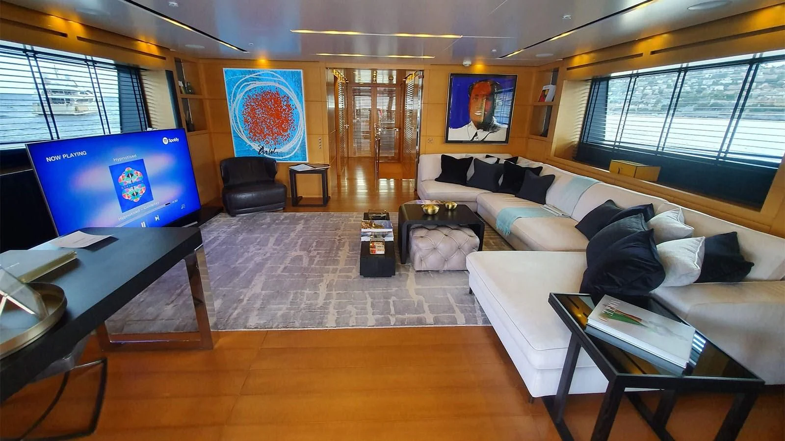 a living room with a large screen aboard AWAY Yacht for Charter