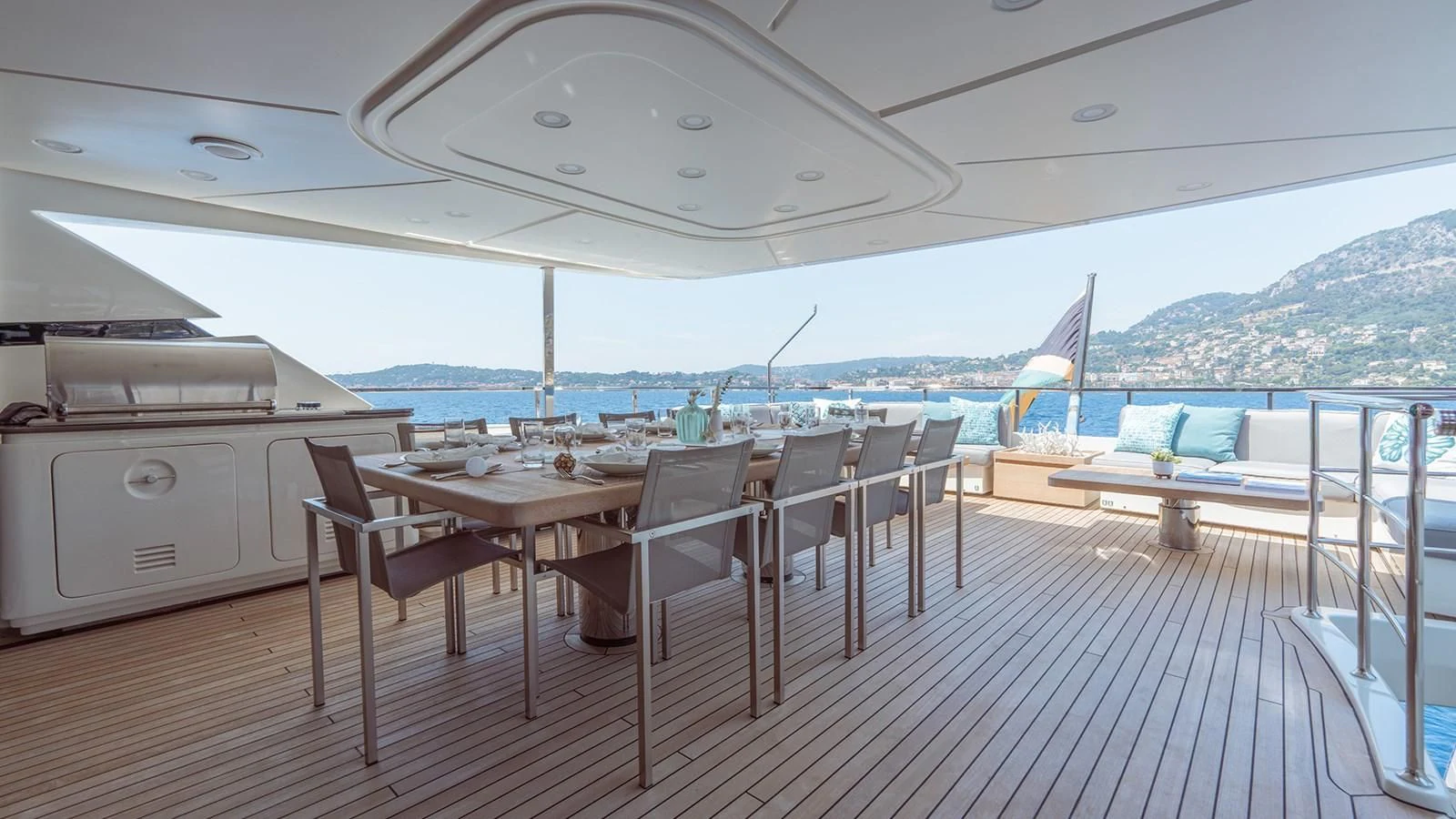 a deck with a table and chairs aboard AWAY Yacht for Charter