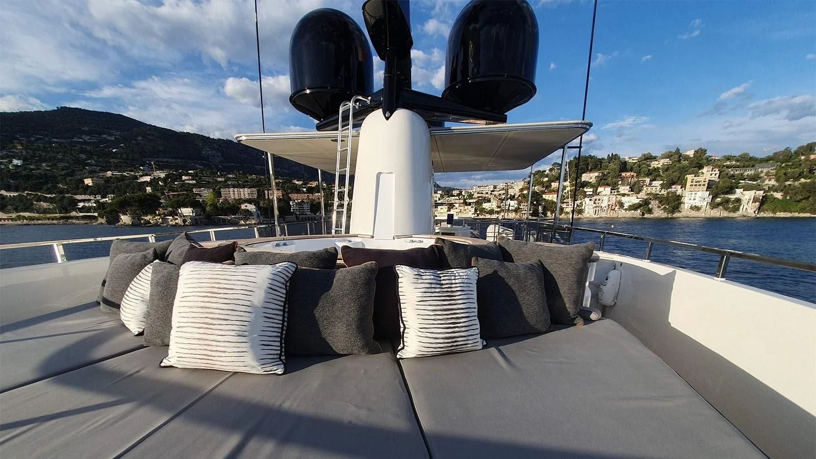 a white bed on a boat aboard AWAY Yacht for Charter