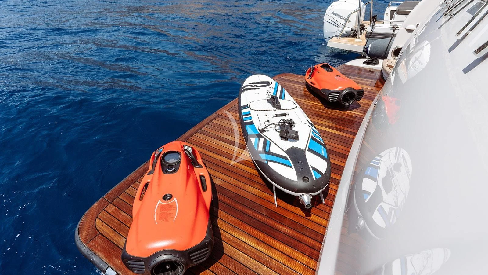 a boat with a kayak and a boat on the water aboard AWAY Yacht for Charter