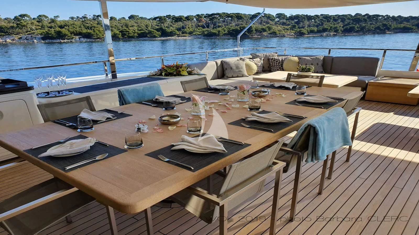 a table with chairs and a couch aboard AWAY Yacht for Charter