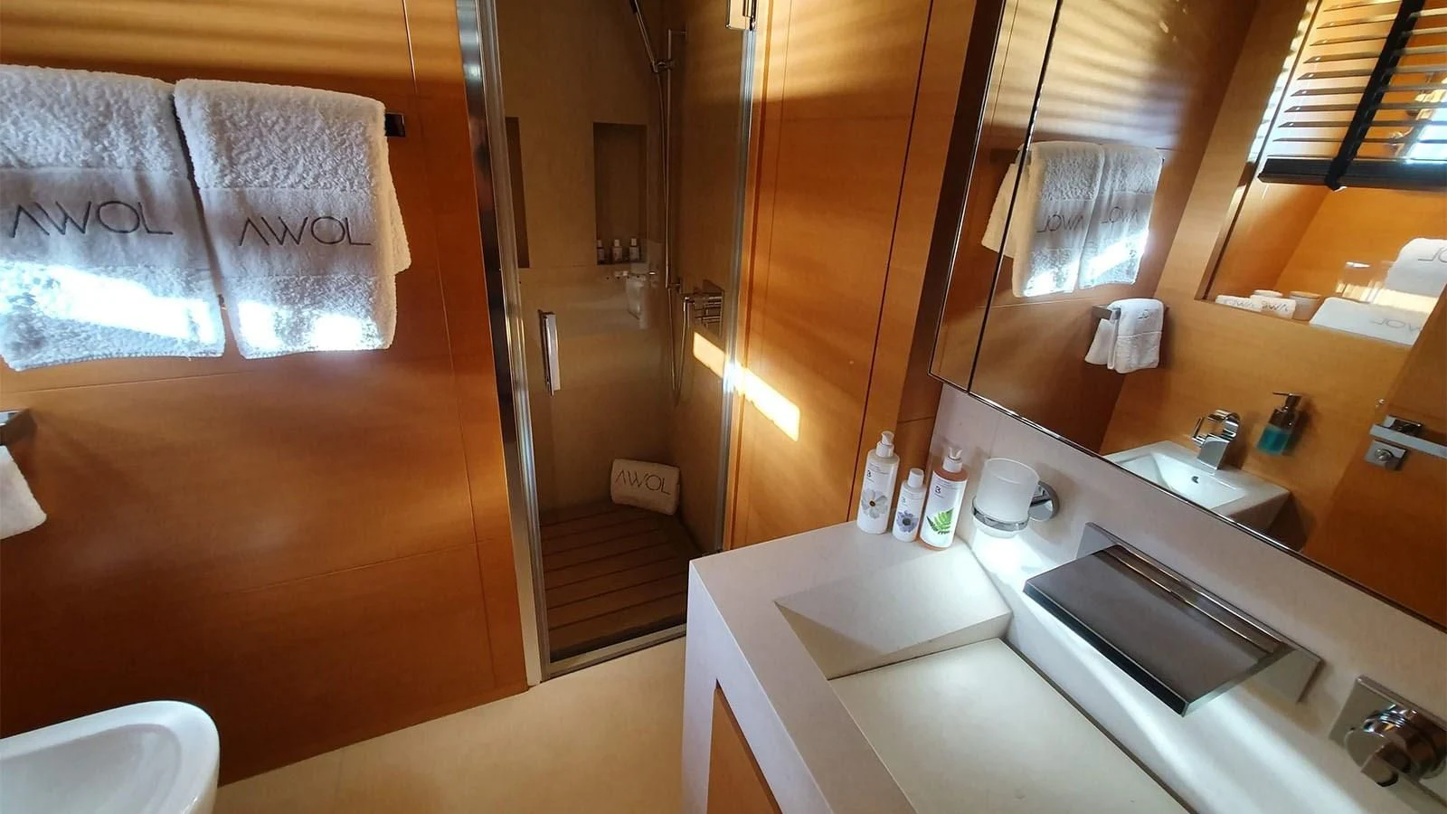 a bathroom with a sink and a mirror aboard AWAY Yacht for Charter