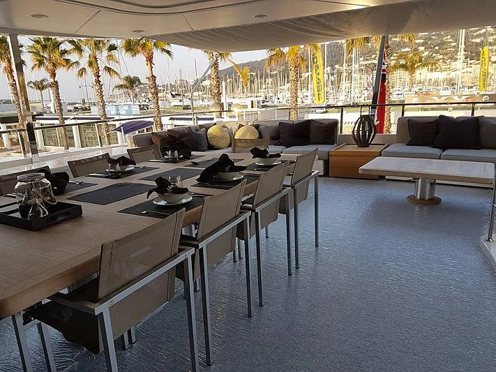 a large room with a table and chairs aboard AWAY Yacht for Charter