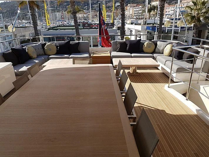 a deck with a couch and chairs aboard AWAY Yacht for Charter