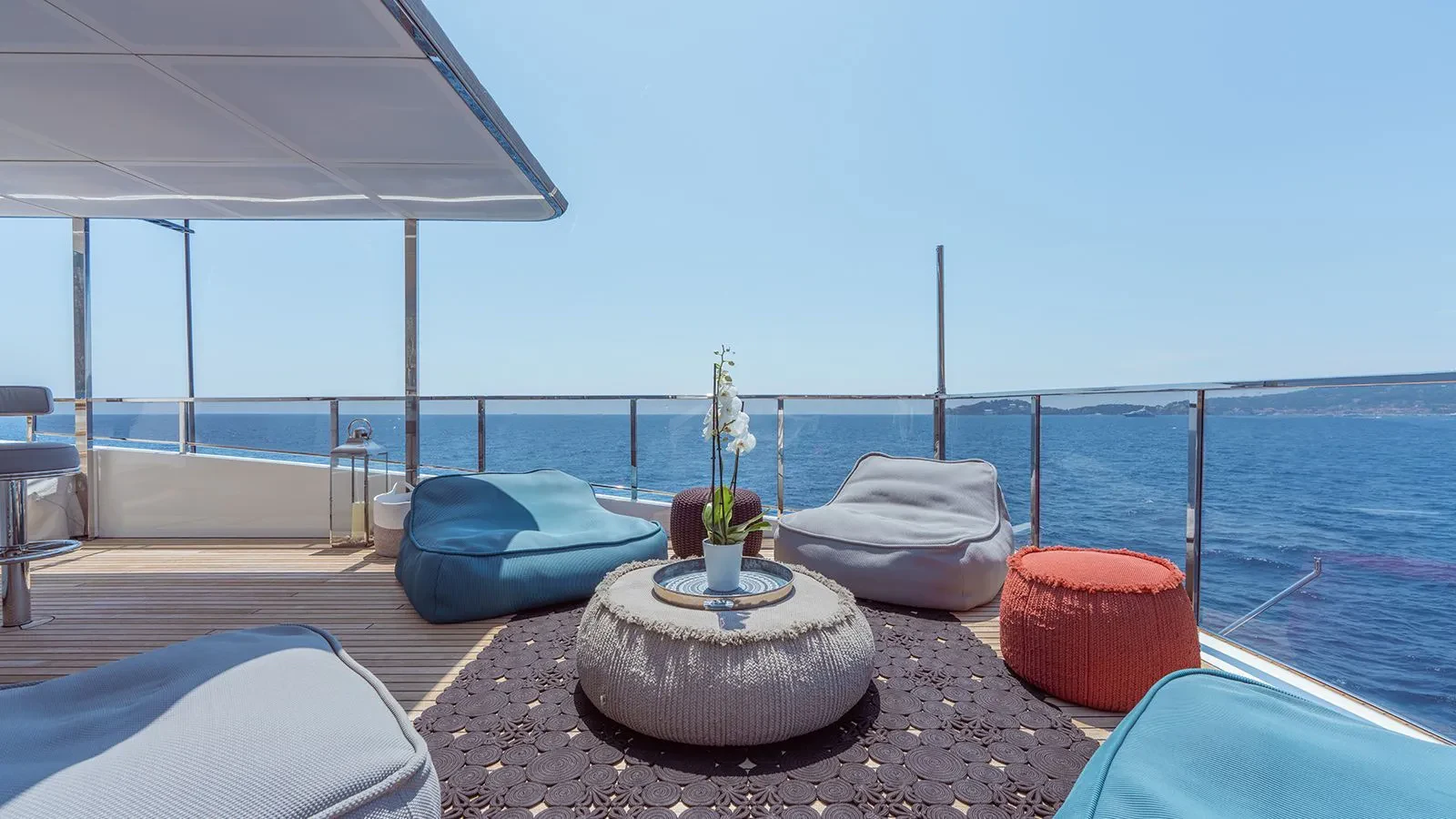a table with chairs on it by the water aboard AWAY Yacht for Charter