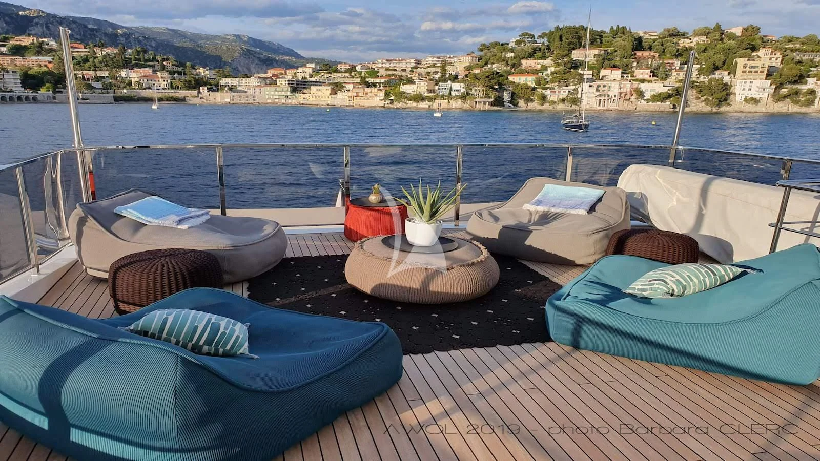 a deck with a view of a city and water aboard AWAY Yacht for Charter