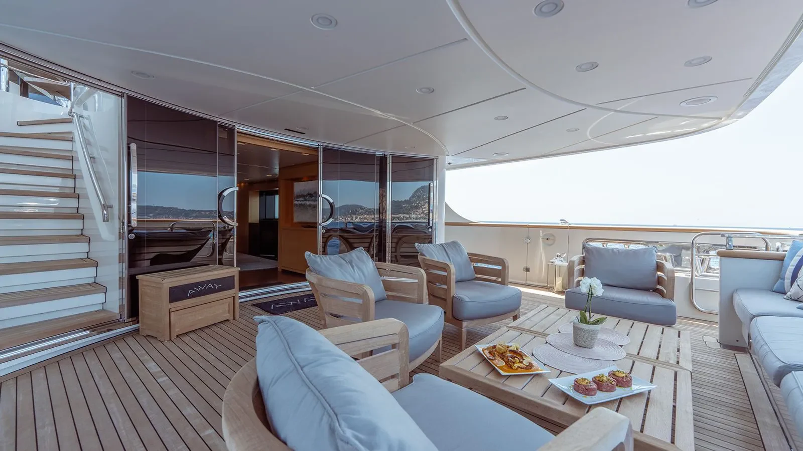 a room with a table chairs and a large window aboard AWAY Yacht for Charter