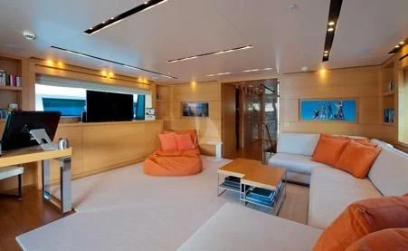a living room with a large screen aboard AWAY Yacht for Charter