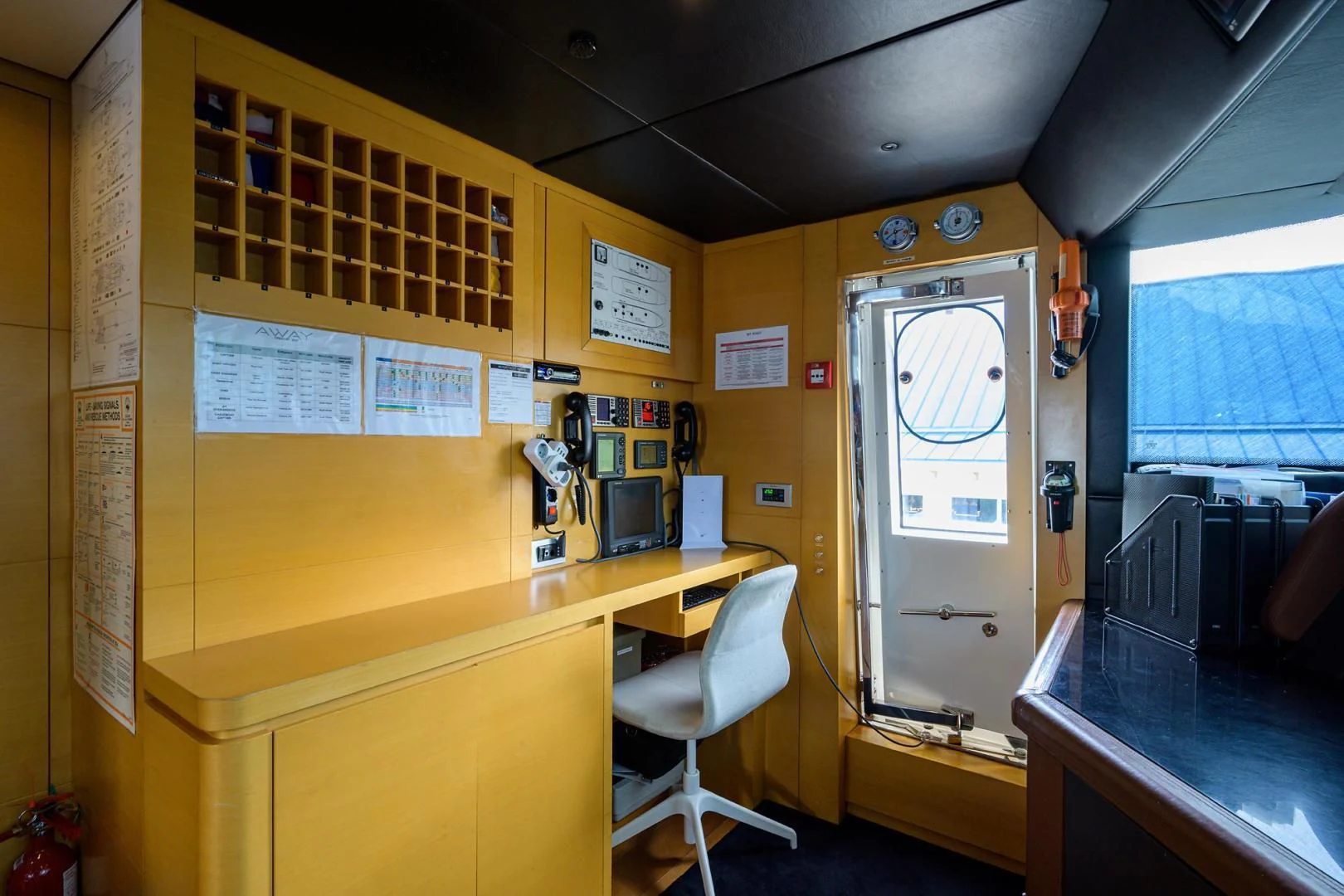 a room with desks and computers aboard AWAY Yacht for Charter