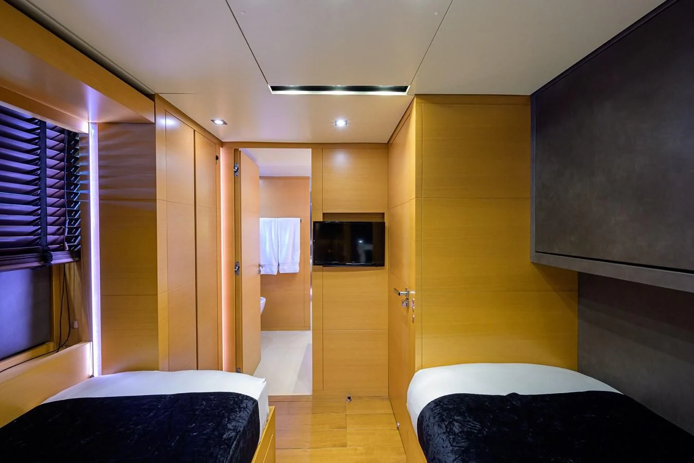 a room with a bed and a mirror aboard AWAY Yacht for Charter