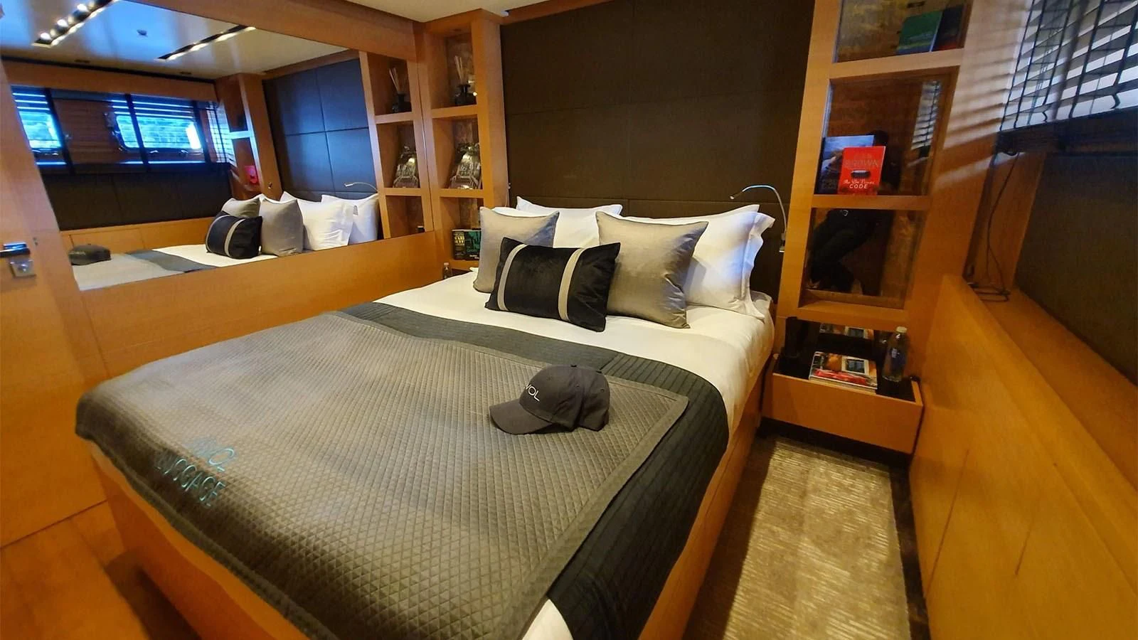 a bedroom with a bed and a bookcase aboard AWAY Yacht for Charter