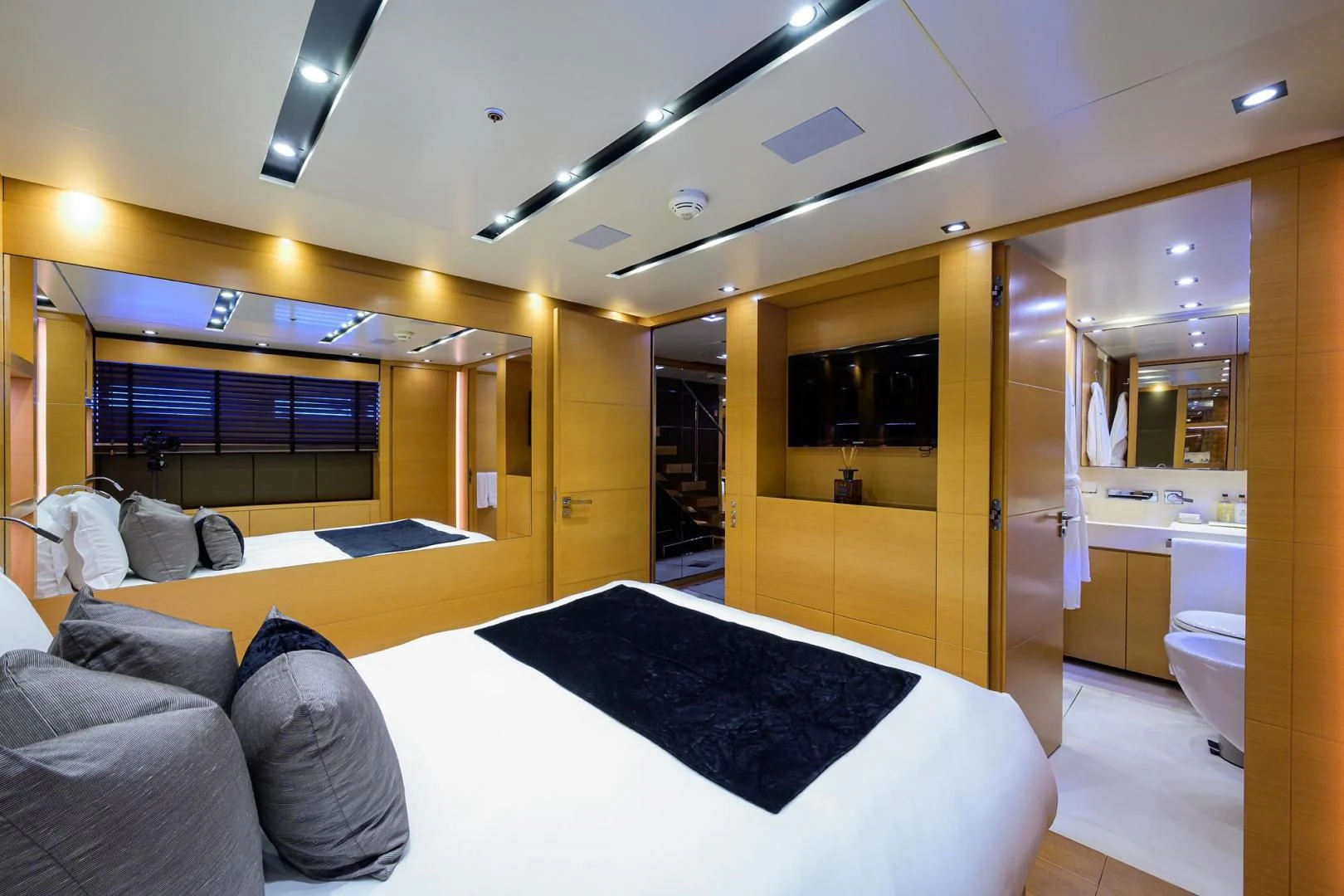 a room with a bed and a couch aboard AWAY Yacht for Charter