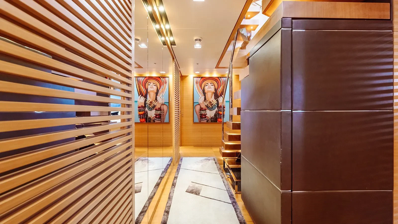 a hallway with a wood door and a painting on the wall aboard AWAY Yacht for Charter
