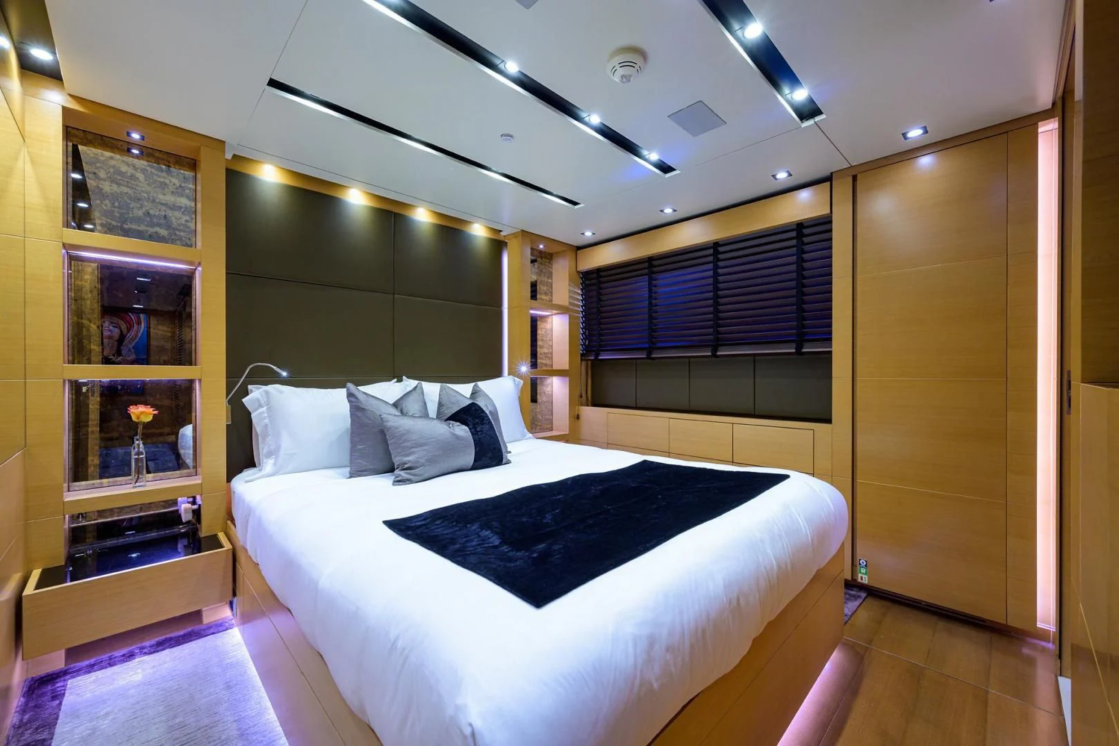 a room with a bed and a mirror aboard AWAY Yacht for Charter
