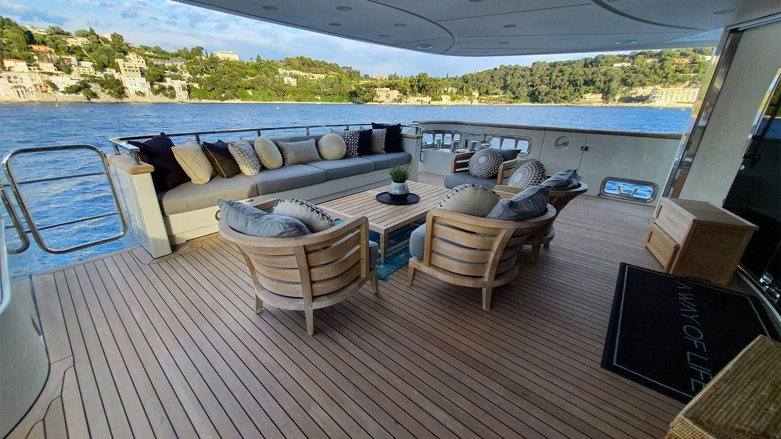 a deck with a large patio and a large window overlooking a city aboard AWAY Yacht for Charter