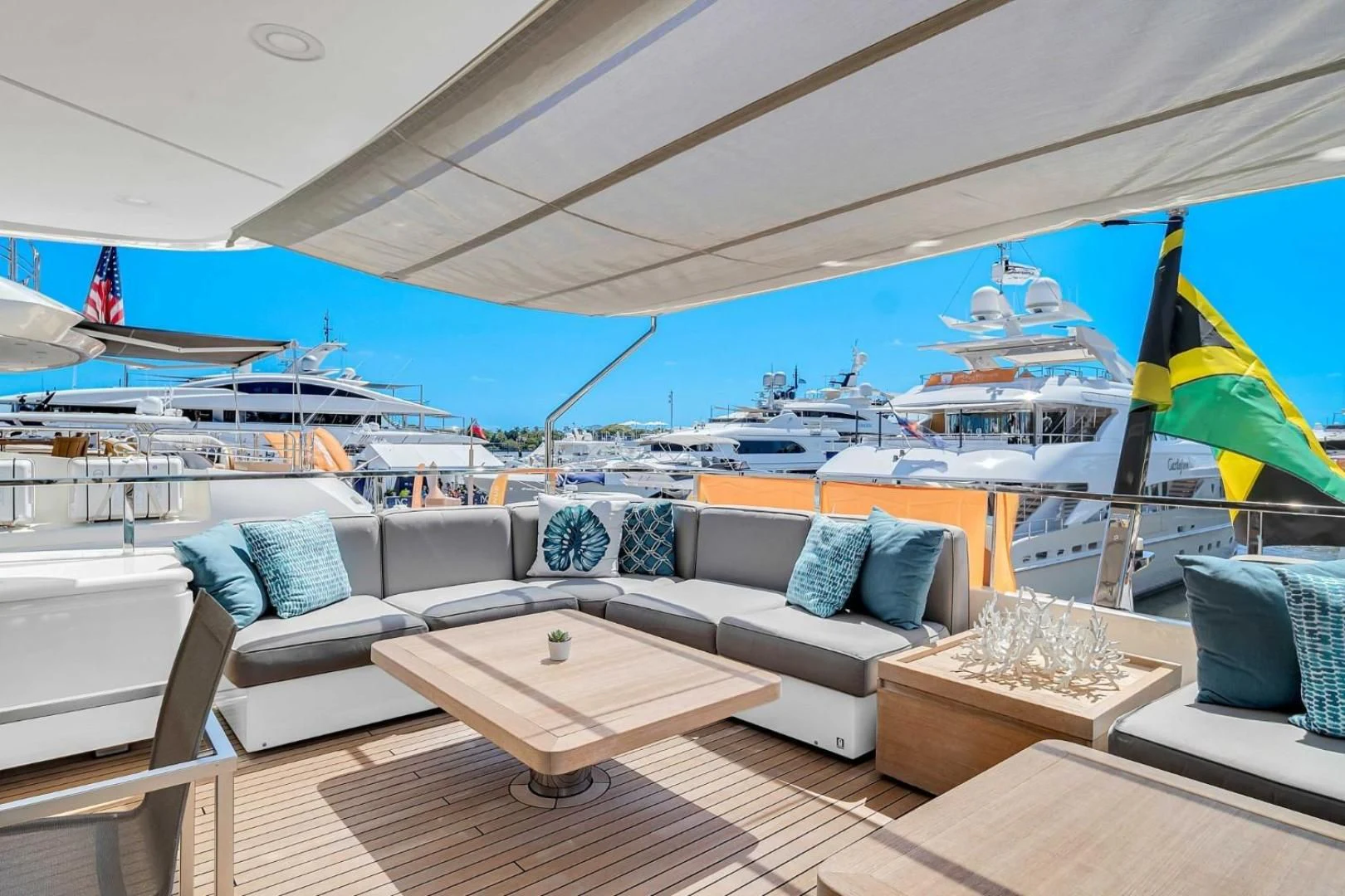 a large lounge area with a large blue and white striped lounge chair and a large white lounge chair aboard AWAY Yacht for Charter