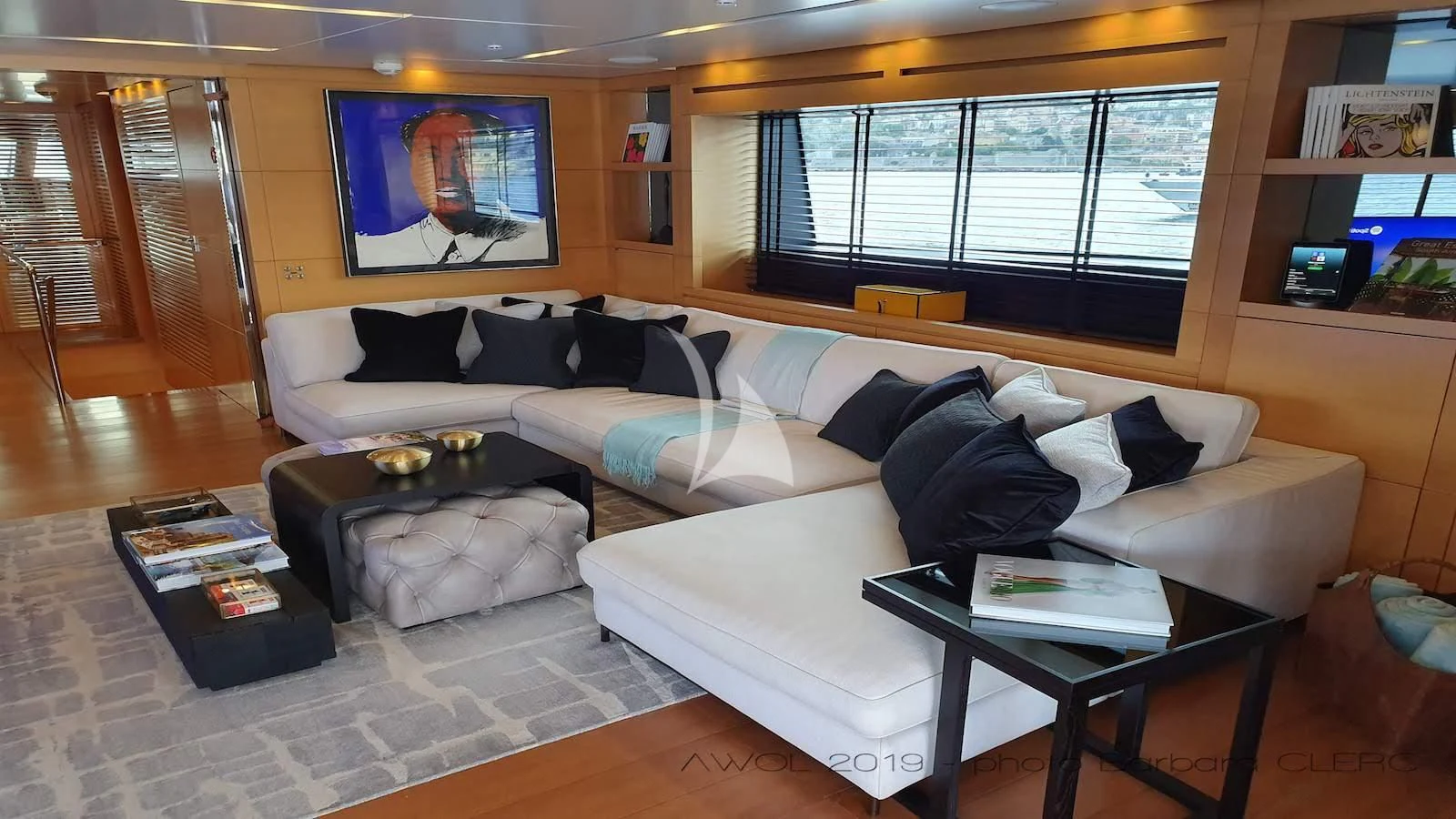 a large living room with a white couch and a coffee table aboard AWAY Yacht for Charter
