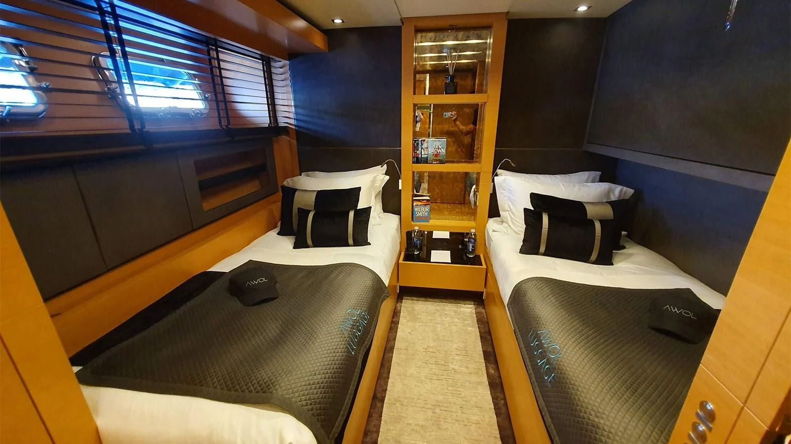 a room with beds and a shelf aboard AWAY Yacht for Charter