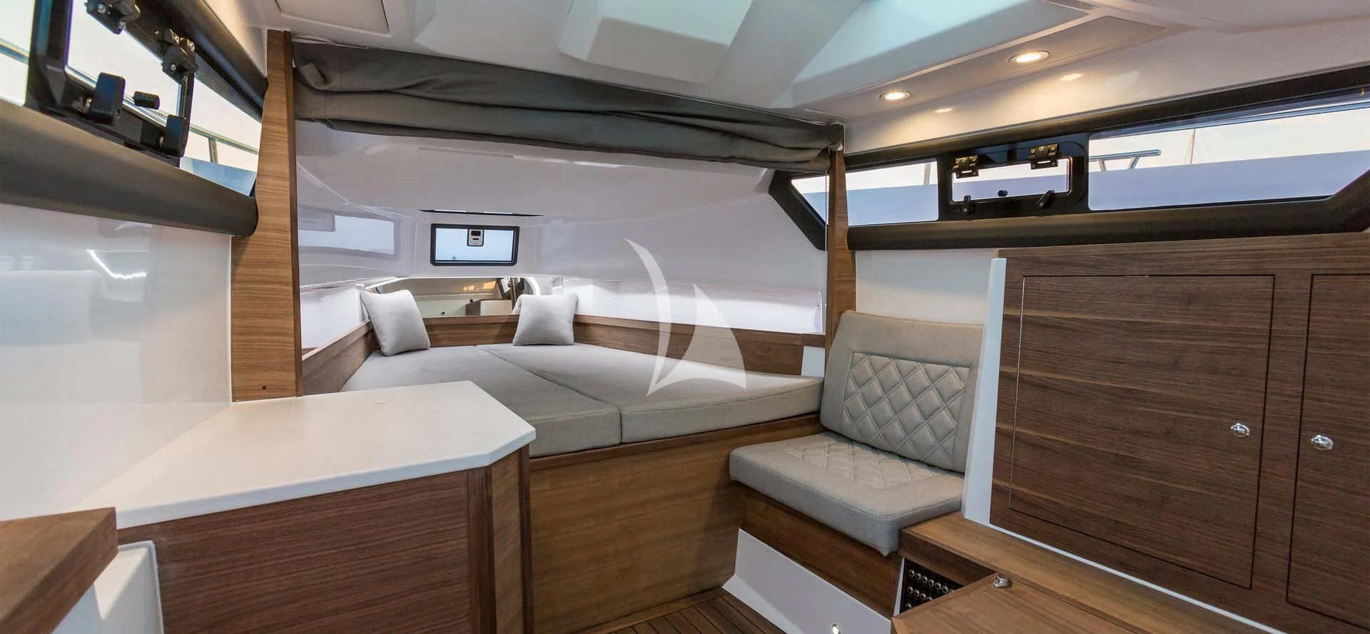 a room with a bed and a couch aboard AWAY Yacht for Charter