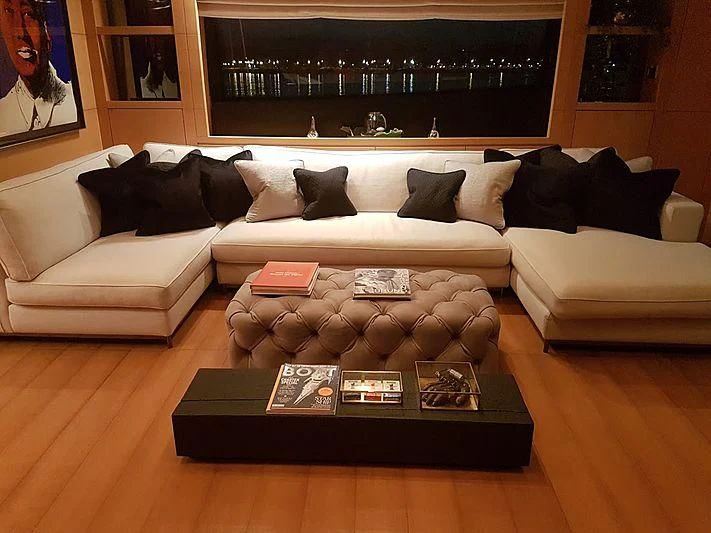 a living room with a couch and coffee table aboard AWAY Yacht for Charter
