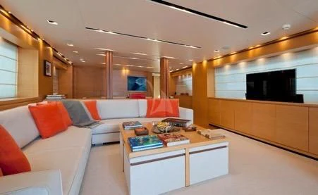 a living room with a white couch and a television aboard AWAY Yacht for Charter