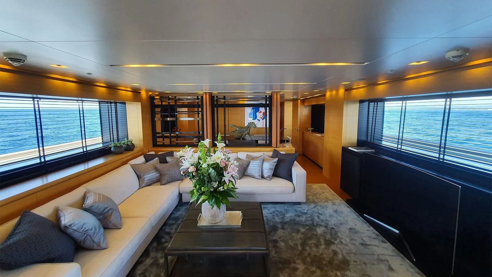 a living room with a large window aboard AWAY Yacht for Charter