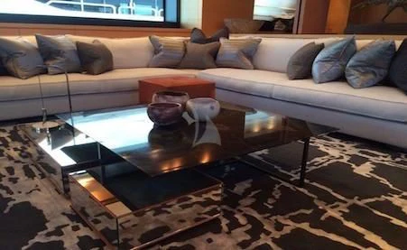 a glass coffee table on a glass coffee table in a living room aboard AWAY Yacht for Charter