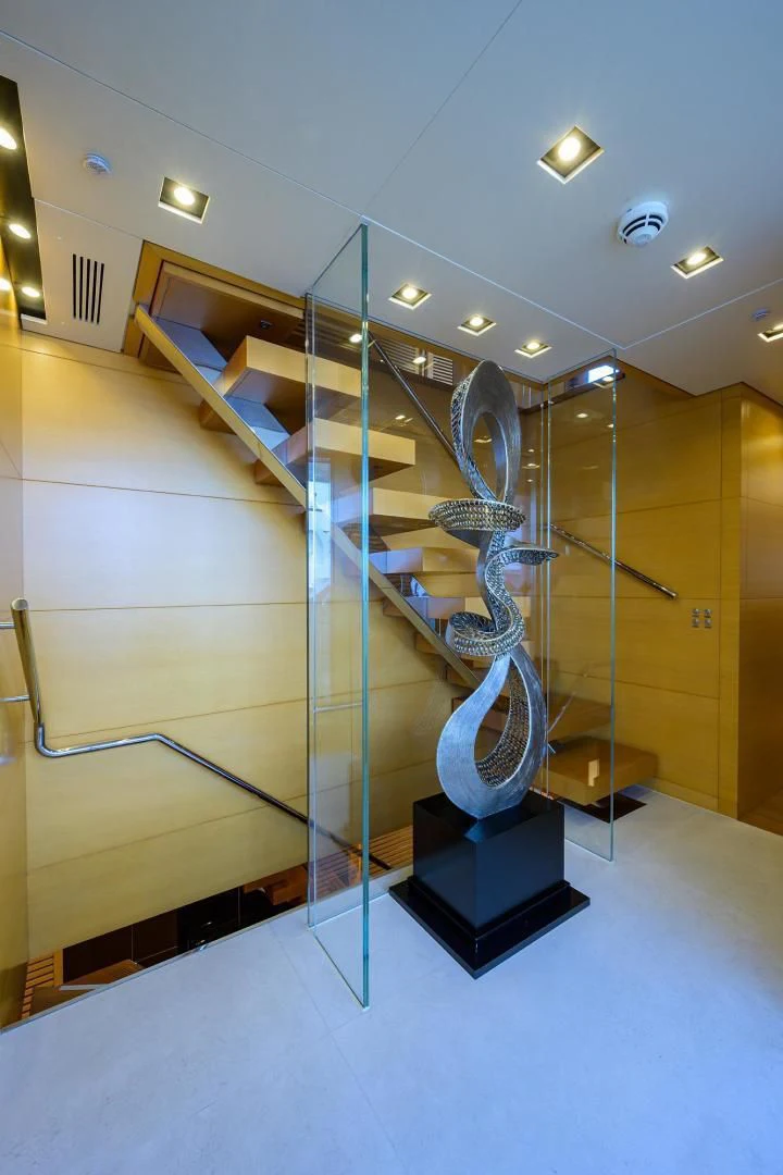 a glass wall with a spiral staircase aboard AWAY Yacht for Charter