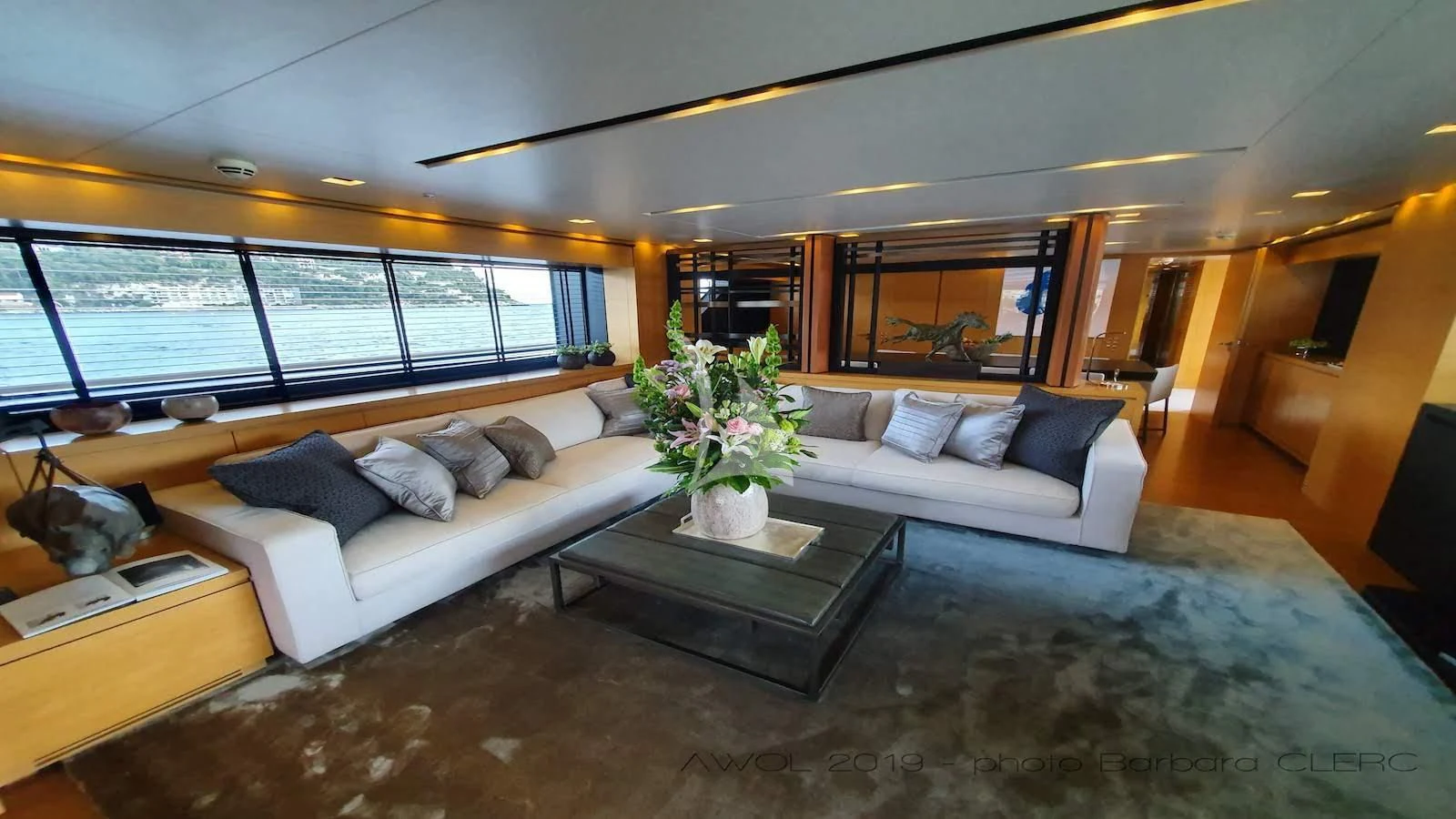 a living room with a large window aboard AWAY Yacht for Charter